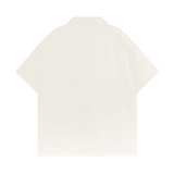 Back view of the beige short-sleeve shirt by Love More Club, clean design with no graphics or embroidery.
