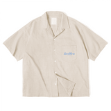 Beige short-sleeve button-up shirt by Love More Club featuring a light blue 