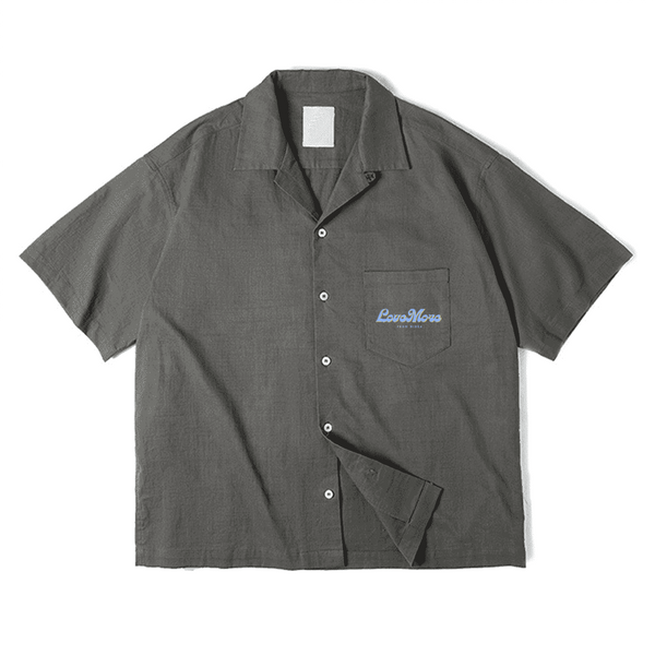 Dark grey short-sleeve button-up shirt by Love More Club with light blue "LoveMore" embroidery on the chest pocket.